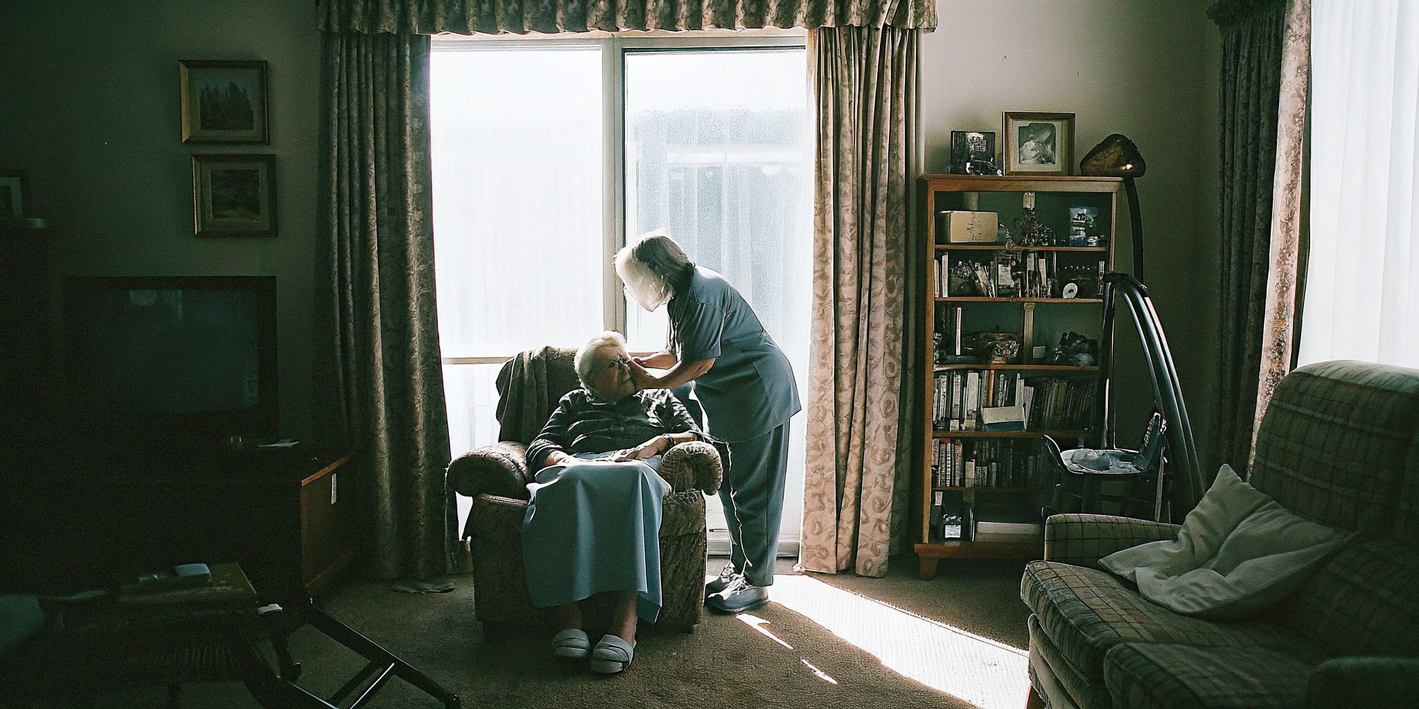 Compassionate home caregiver sitting with a senior client in Castle Pines, Colorado