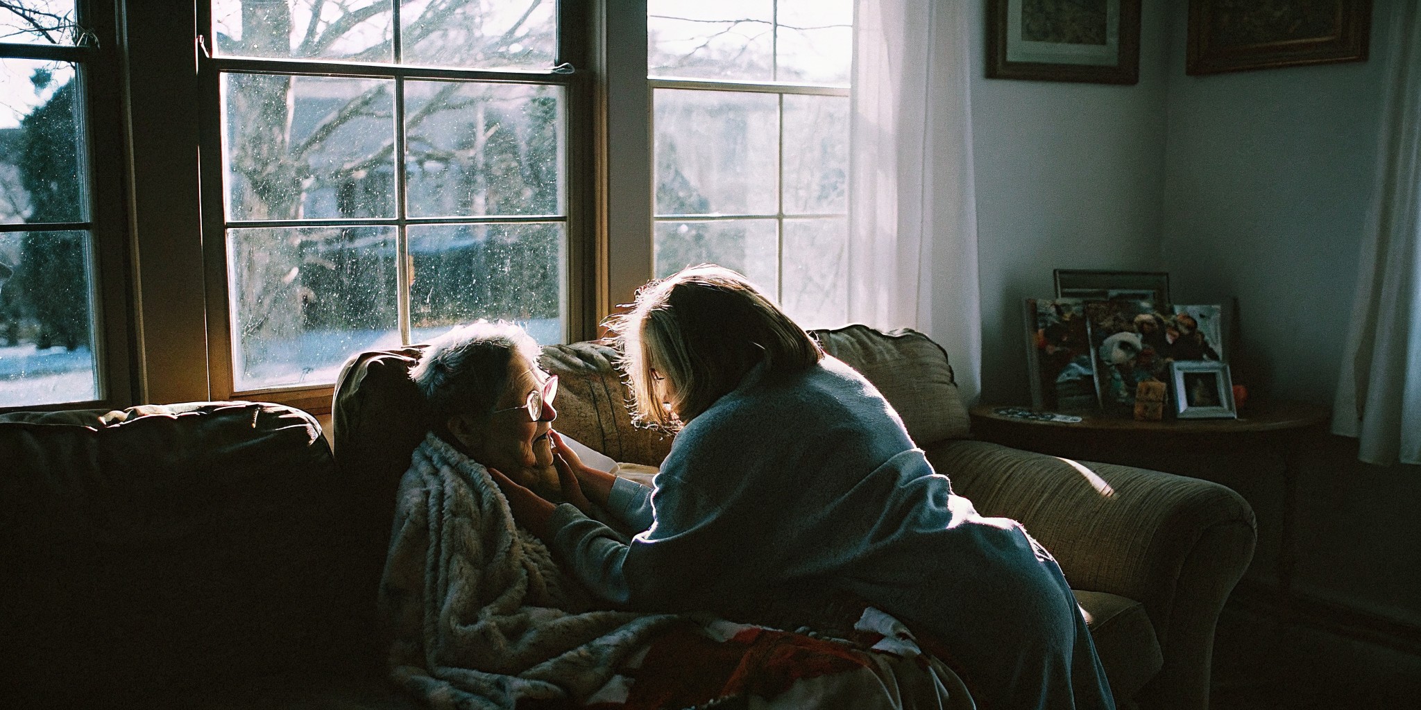 Home caregiver sharing conversation with a senior woman in her Castle Pines home