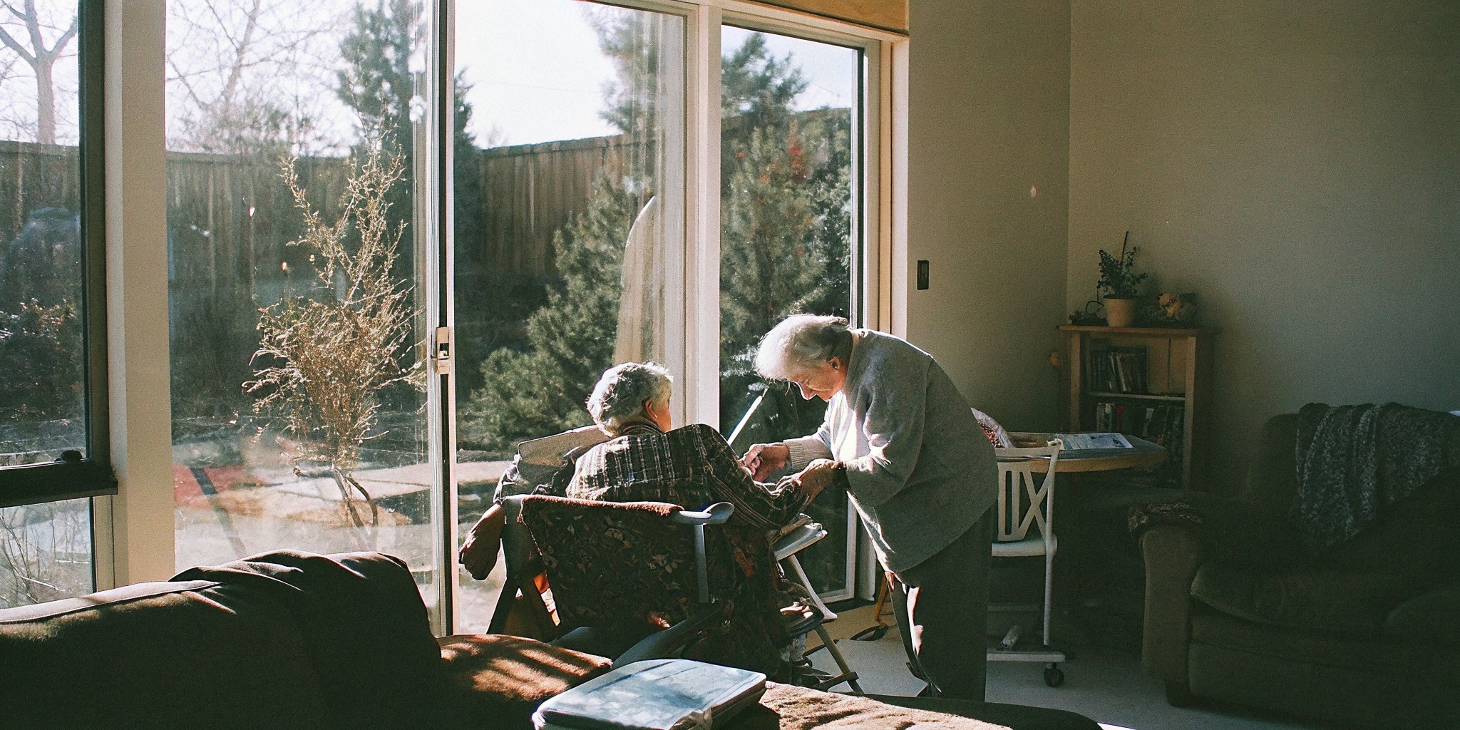 Compassionate home caregiver sitting with a senior client in Parker, Colorado