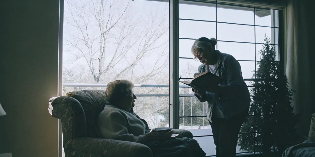 Senior woman and caregiver preparing a meal together at home